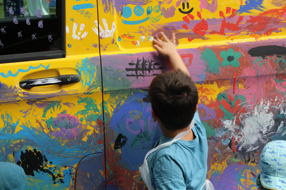 Kinder bemahlen ein Auto